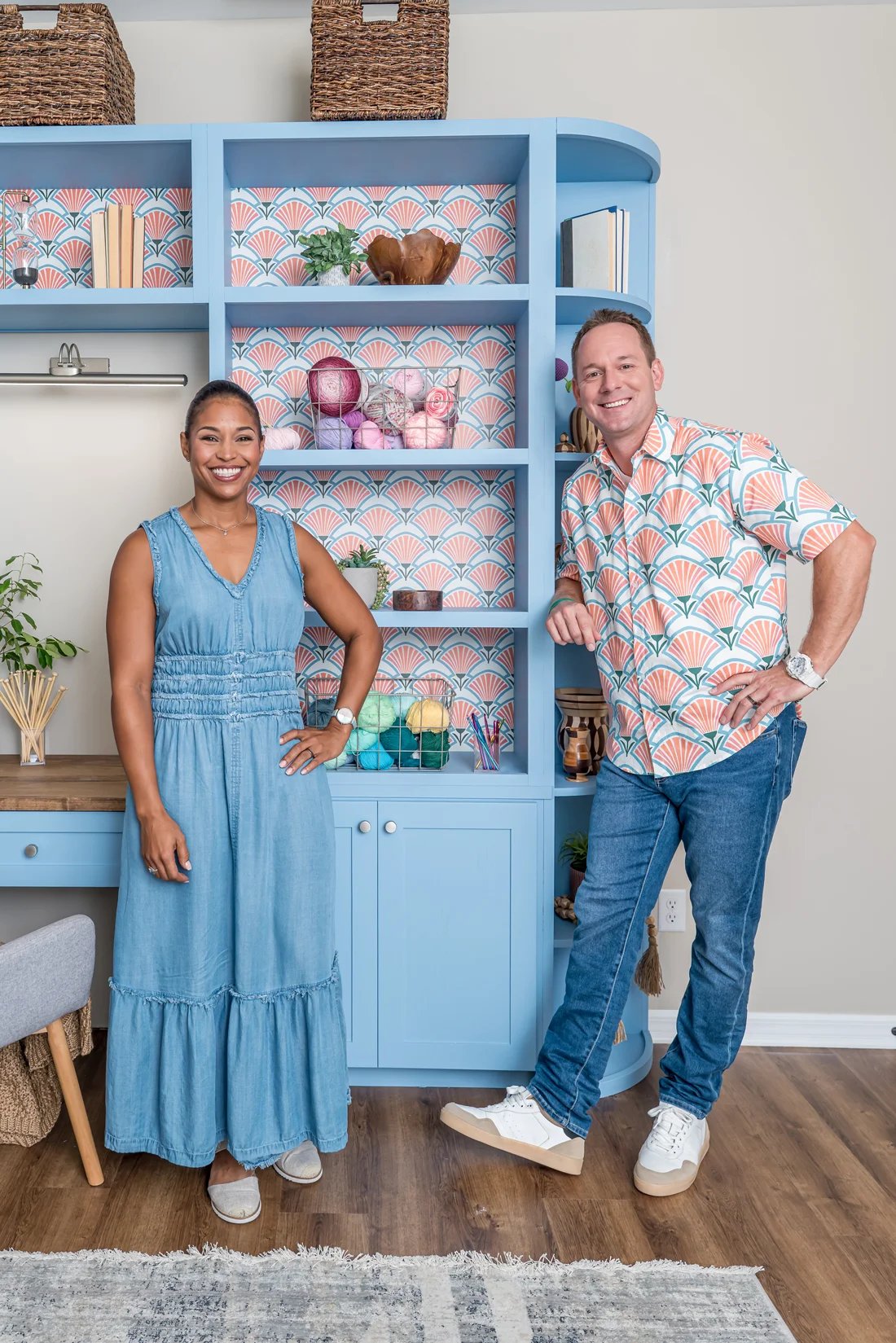Brian and Mika standing in front of shelves that feature wallpaper as the shelf backing.