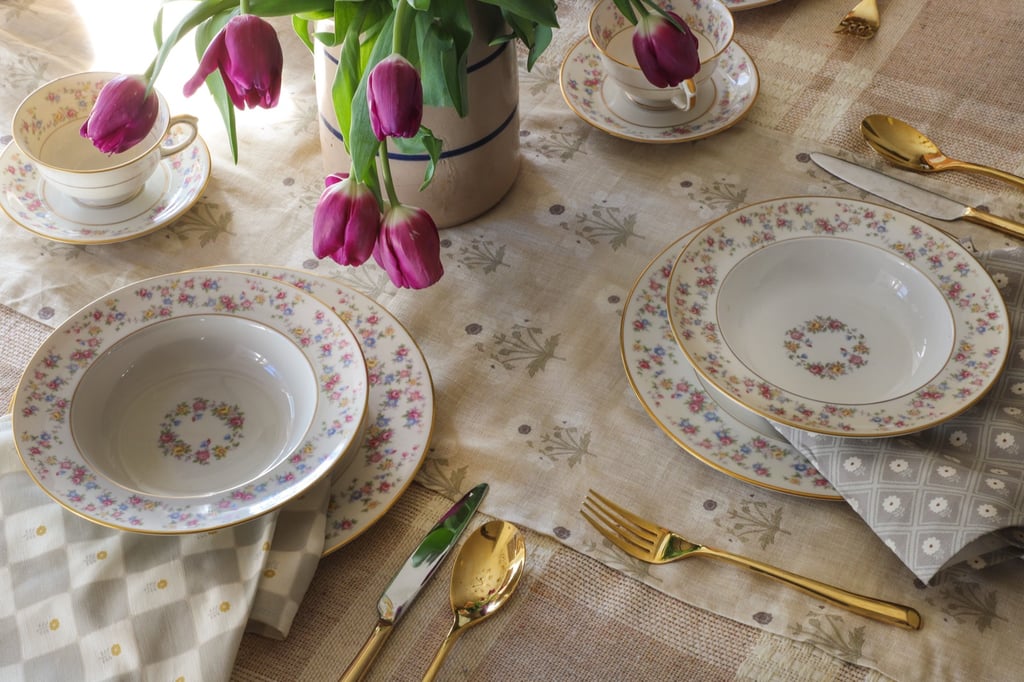 a custom table setting using custom printed table runners and napkins featuring vintage designs