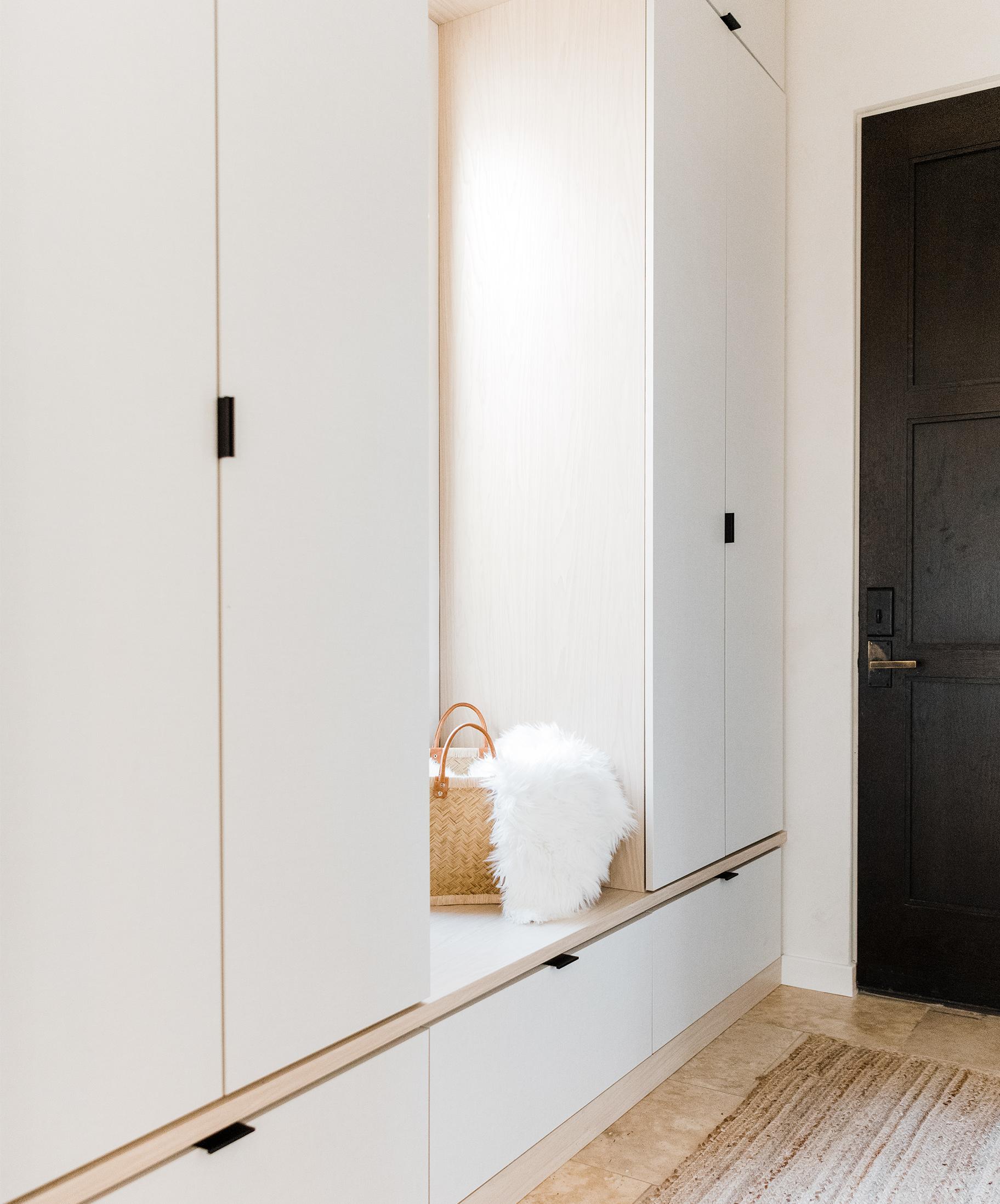 Mudroom closet design for hallway with a built in bench by California Closets