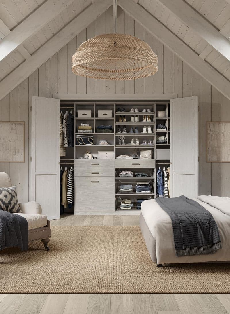 Shoe storage shelves with fences to keep in place in a reach in by California Closets