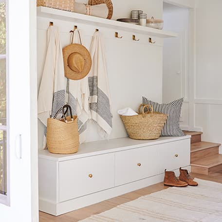 Entryway storage for mudroom items with storage bench by California Closets