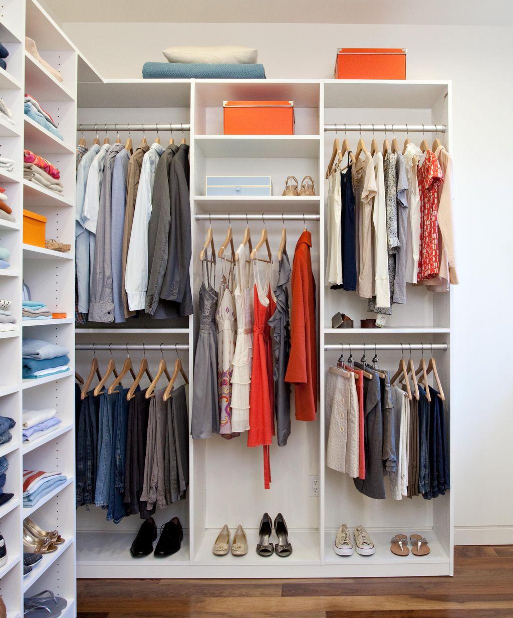 Custom closet designed with open shelving and dresser drawers in white finish by California Closests