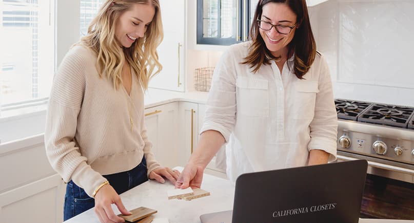 In home design consultation with a professional designer taking notes on the space and measurements by California Closets