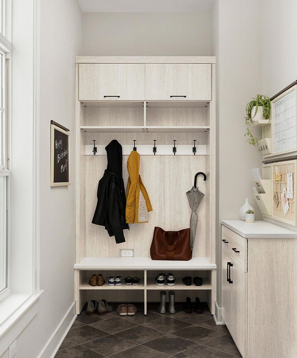 Entrway storage with bench and coat-hooks by California Closets