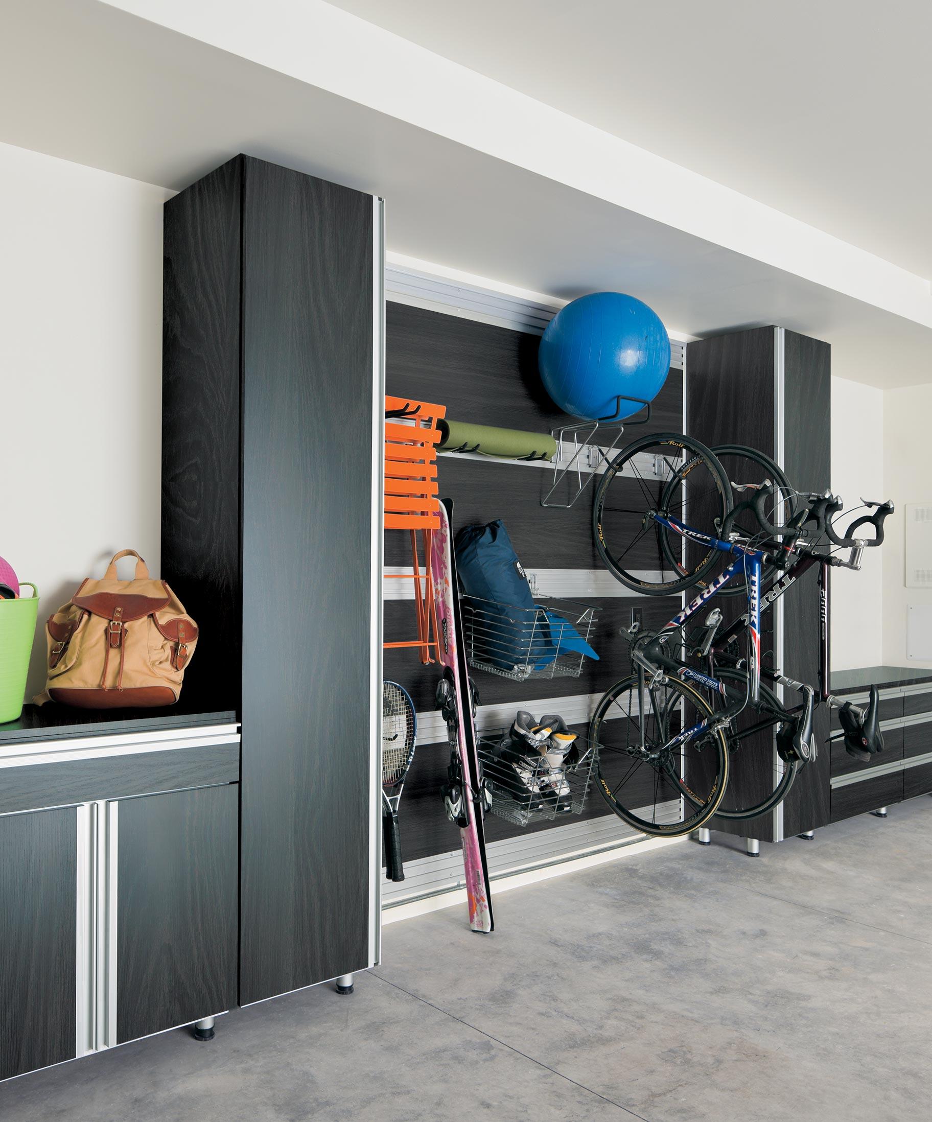 Garage storage solution in a shadown black finish with versatile hooks to hold tall items designed by California Closets