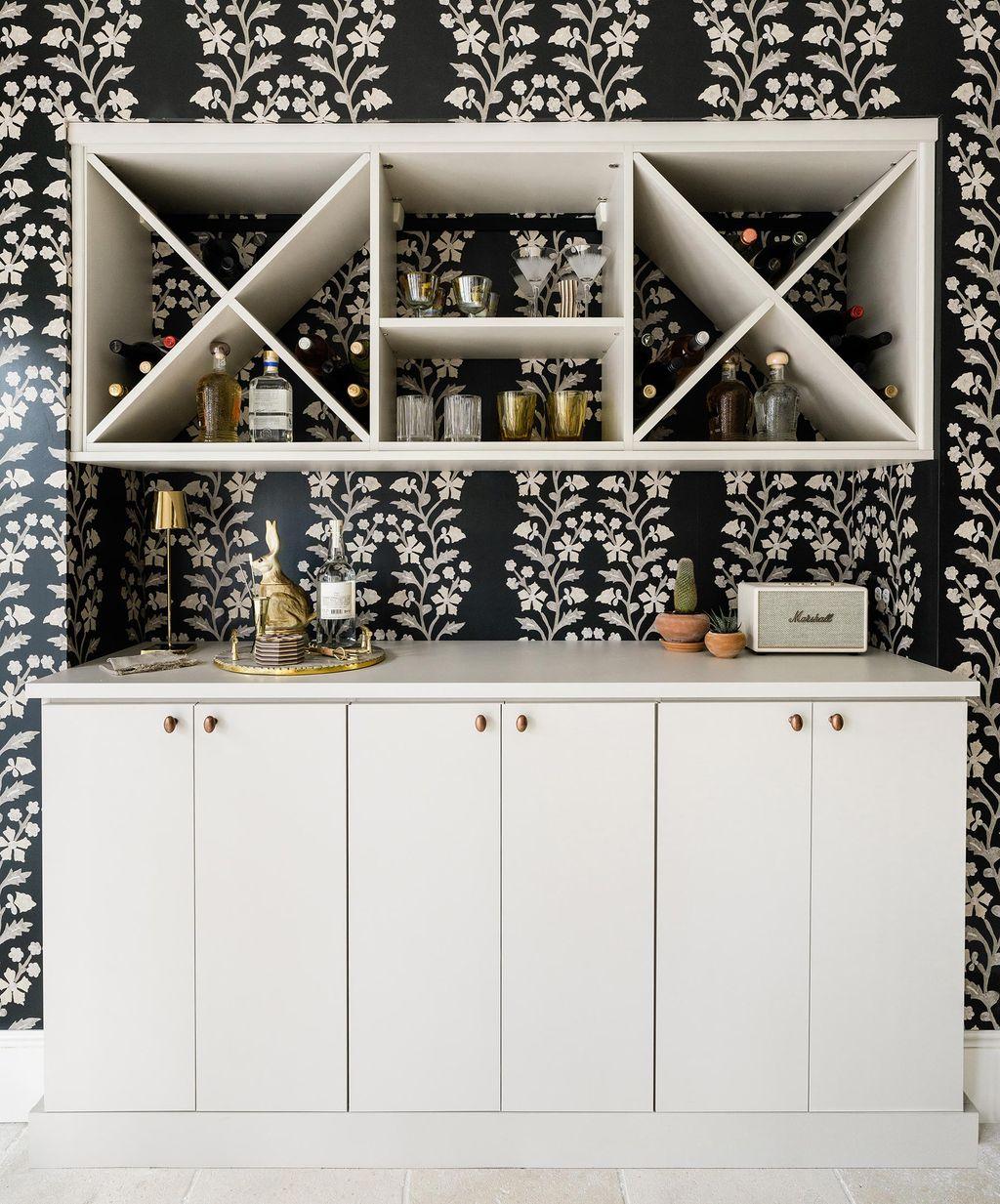Home wine and liquor storage with cubbies and cabinets in white finish by California Closets