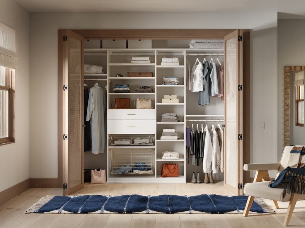 Reach in closet floor-based shoe shelves and basket storage by California Closets
