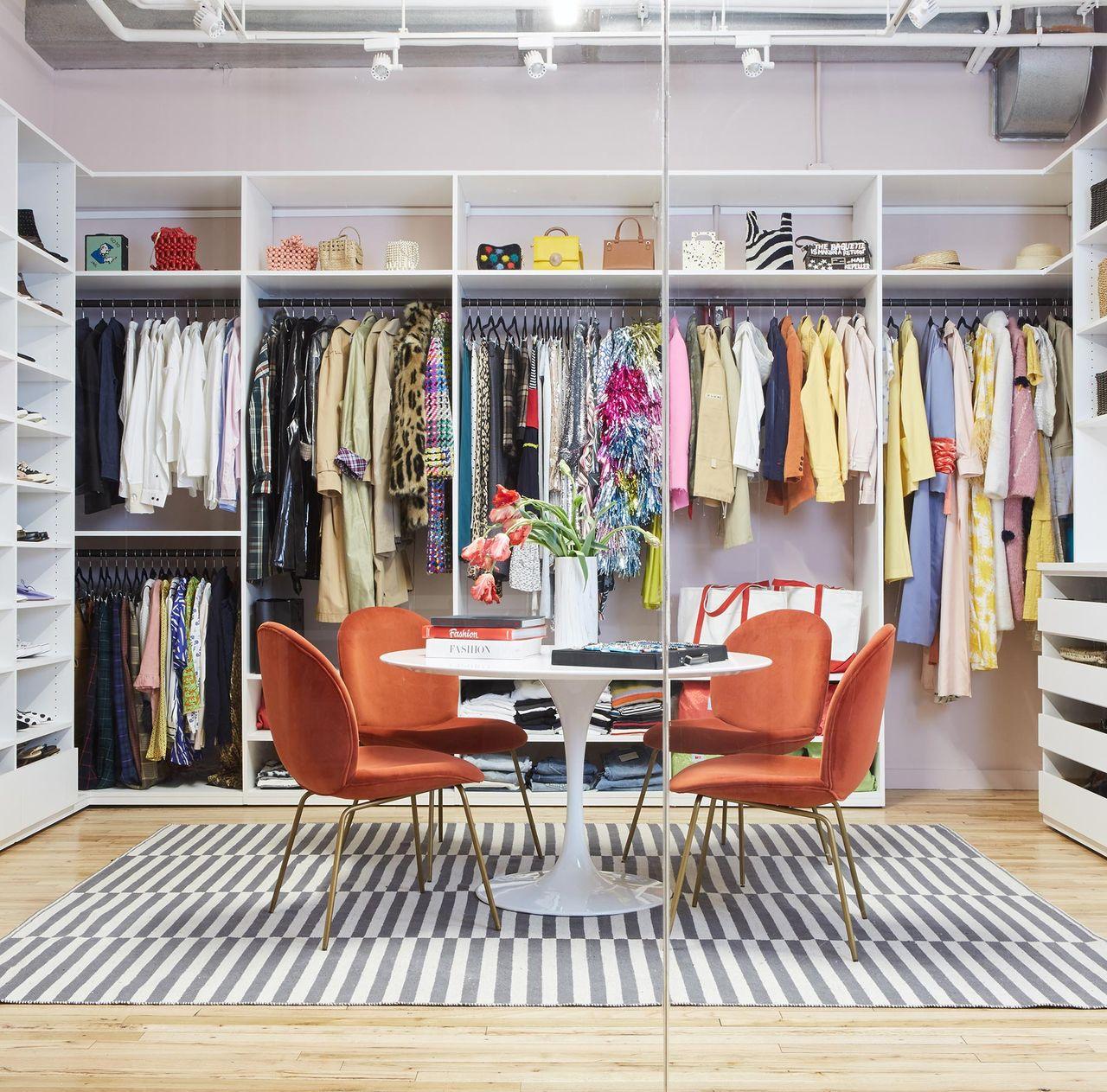 Custom showroom layout design with shelves, cabinets and a conference table by California Closets
