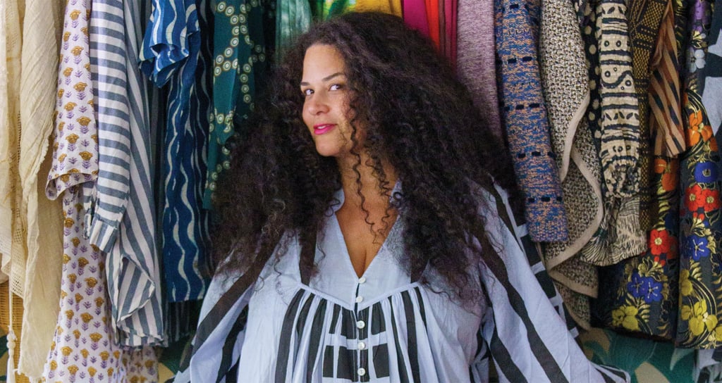 Justina Blakeney's walk in closet with colorful wallpaper and wardrobe created by California Closets