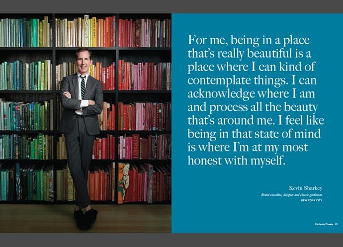 Kevin Sharkey standing in front of a color-organized bookshelf with a quote about beauty and self-reflection