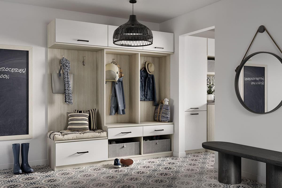 Mudroom customized storage cabinets, bench and clothes hooks designed by California Closets. Activate to enhance image.