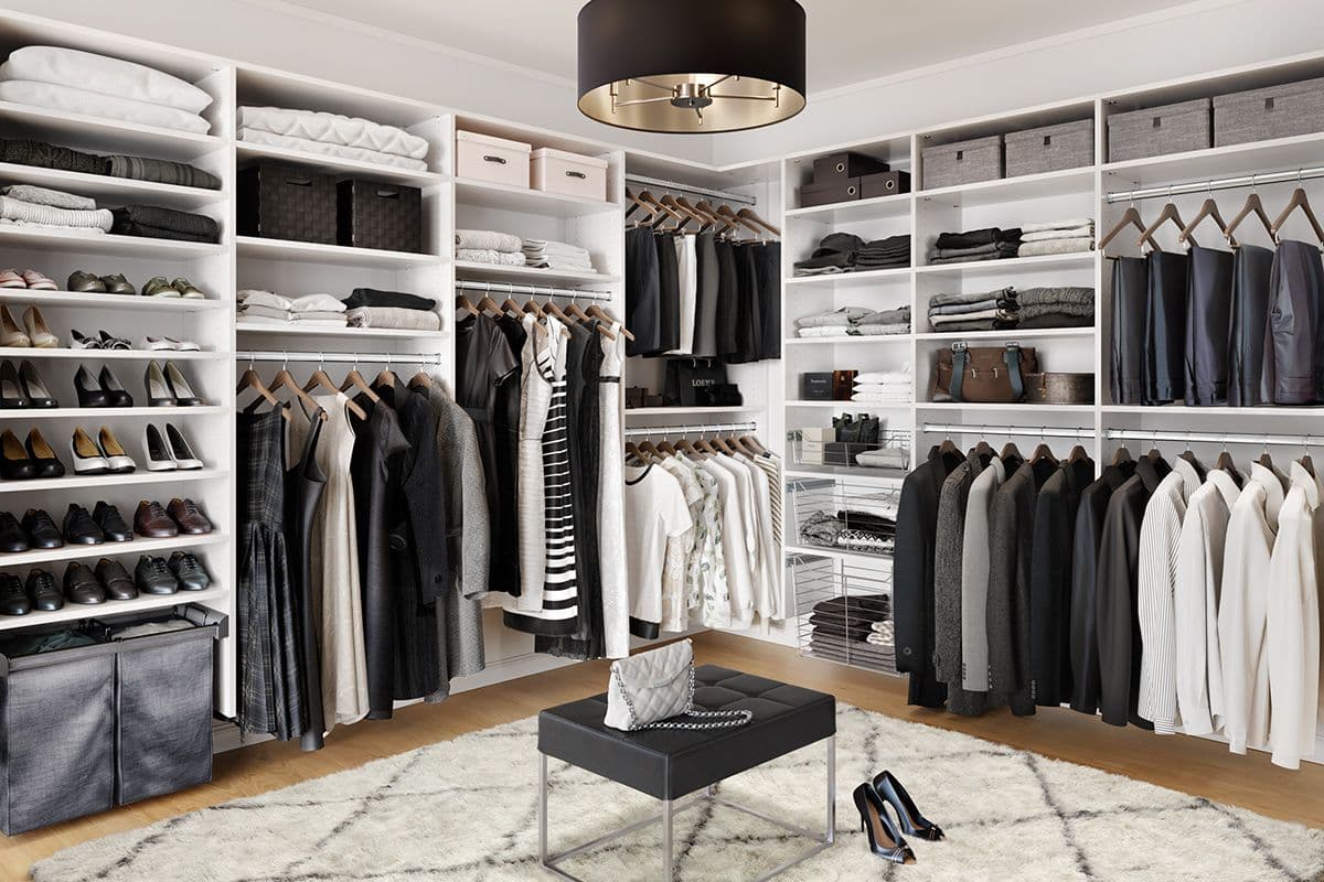 Classic walk in closet layout design in white finish with shoe shelves built in by California Closets. Activate to enhance image.