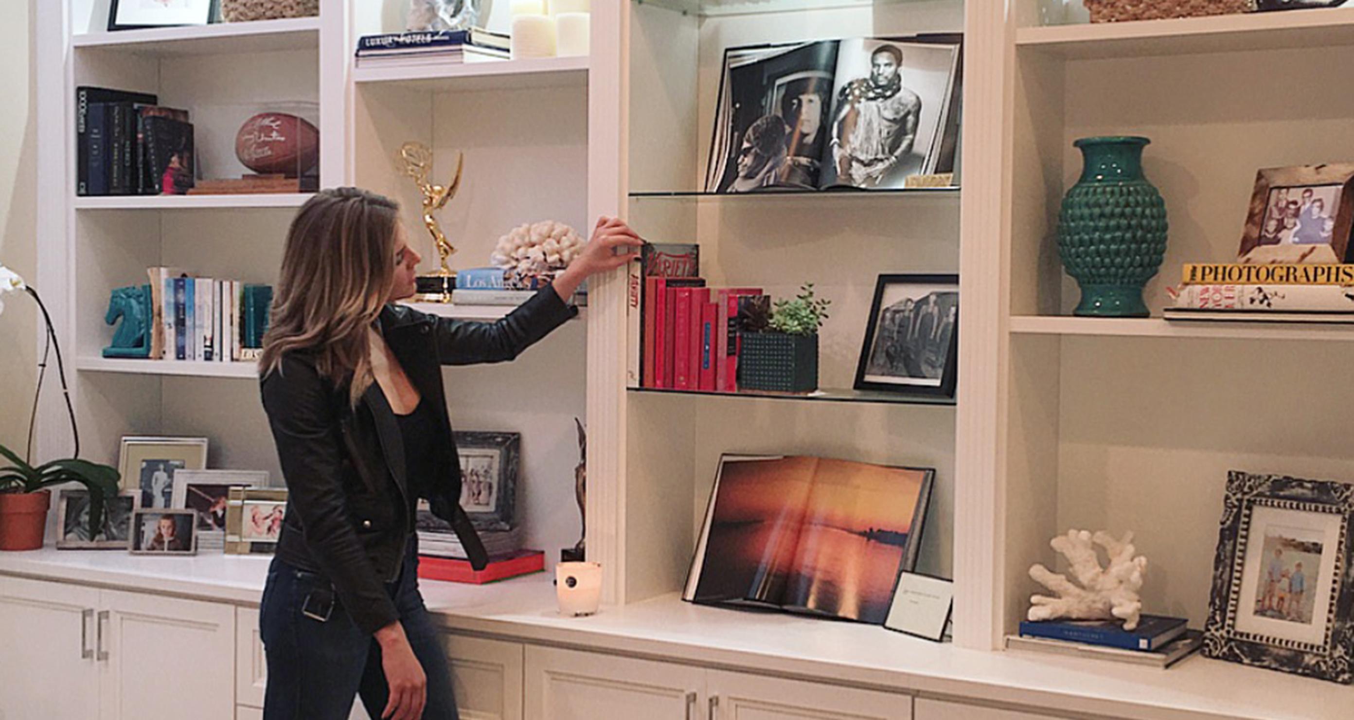 Charissa Thompson's custom built in bookshelves with storage cabinets and drawers by California Closets