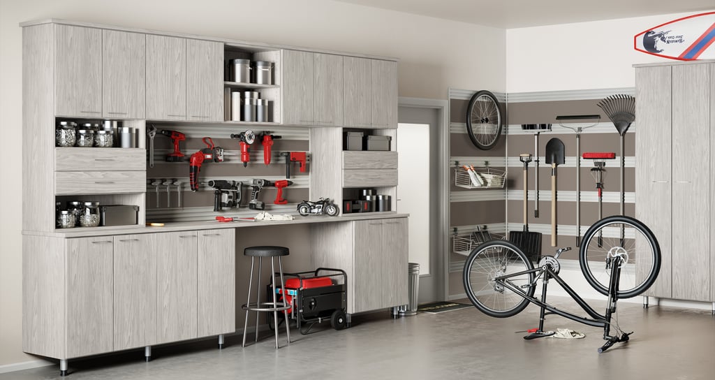Light finish garage storage cabinets and countertop space for tools by California Closets