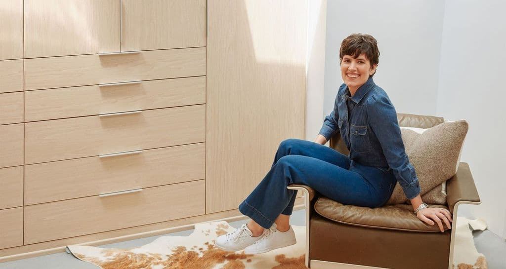 A walk in closet in natural wood grain finish created in a mid-century LA home for Elise Loehnen by California Closets