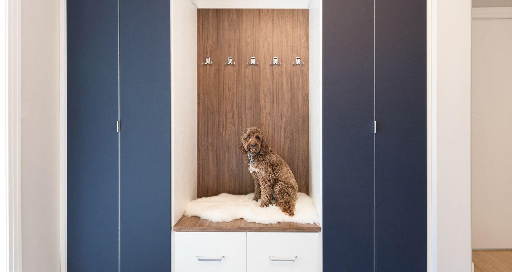 Custom entry mudroom storage cabinets and seated bench or pet bed by California Closets