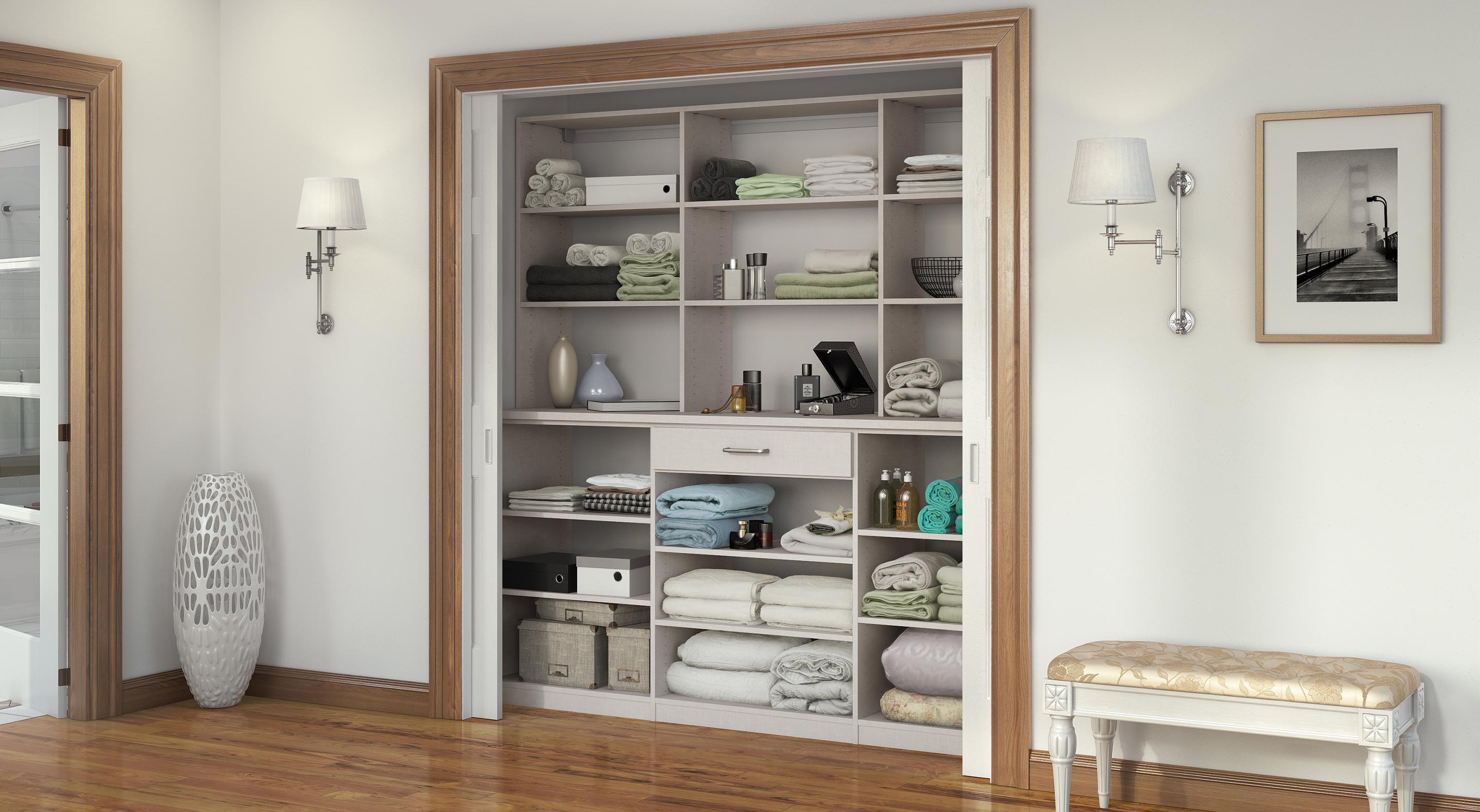 Hall linen reach in closet shelving and drawer organizer by California Closets