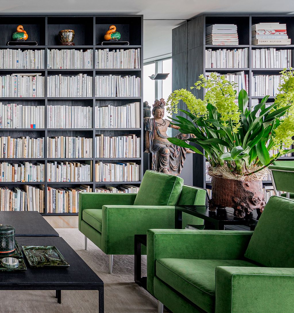 Bookshelves in living room designed to elevate the space with mirrored walls by California Closets