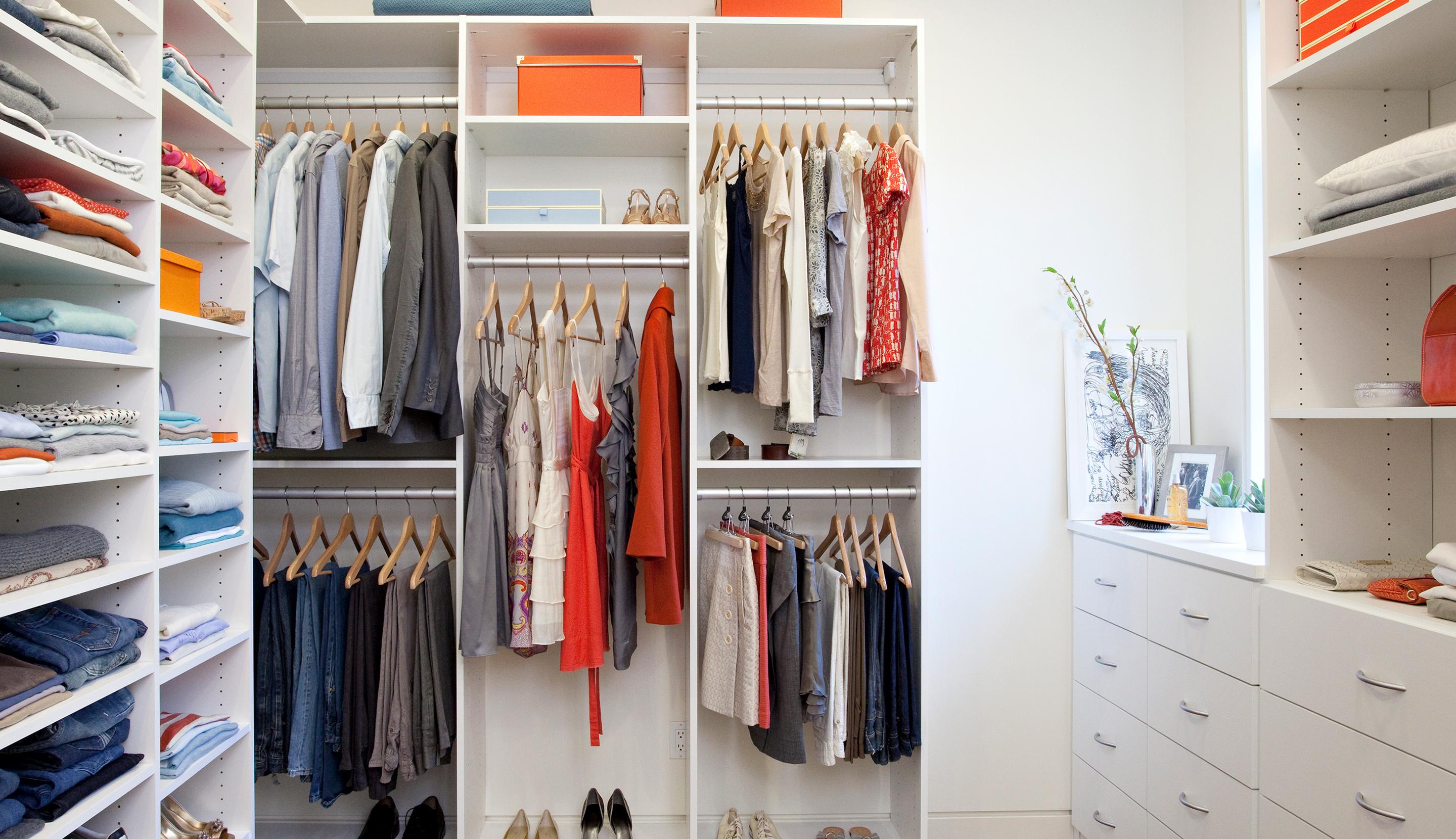 Simple closet system design with bright white finished shoe racks, drawers, poles, cabents created by California Closets