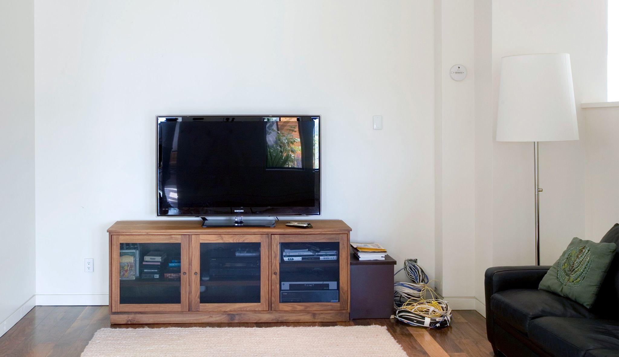 Before redesign for a personalized entertainment center with custom storage cabinets by California Closets
