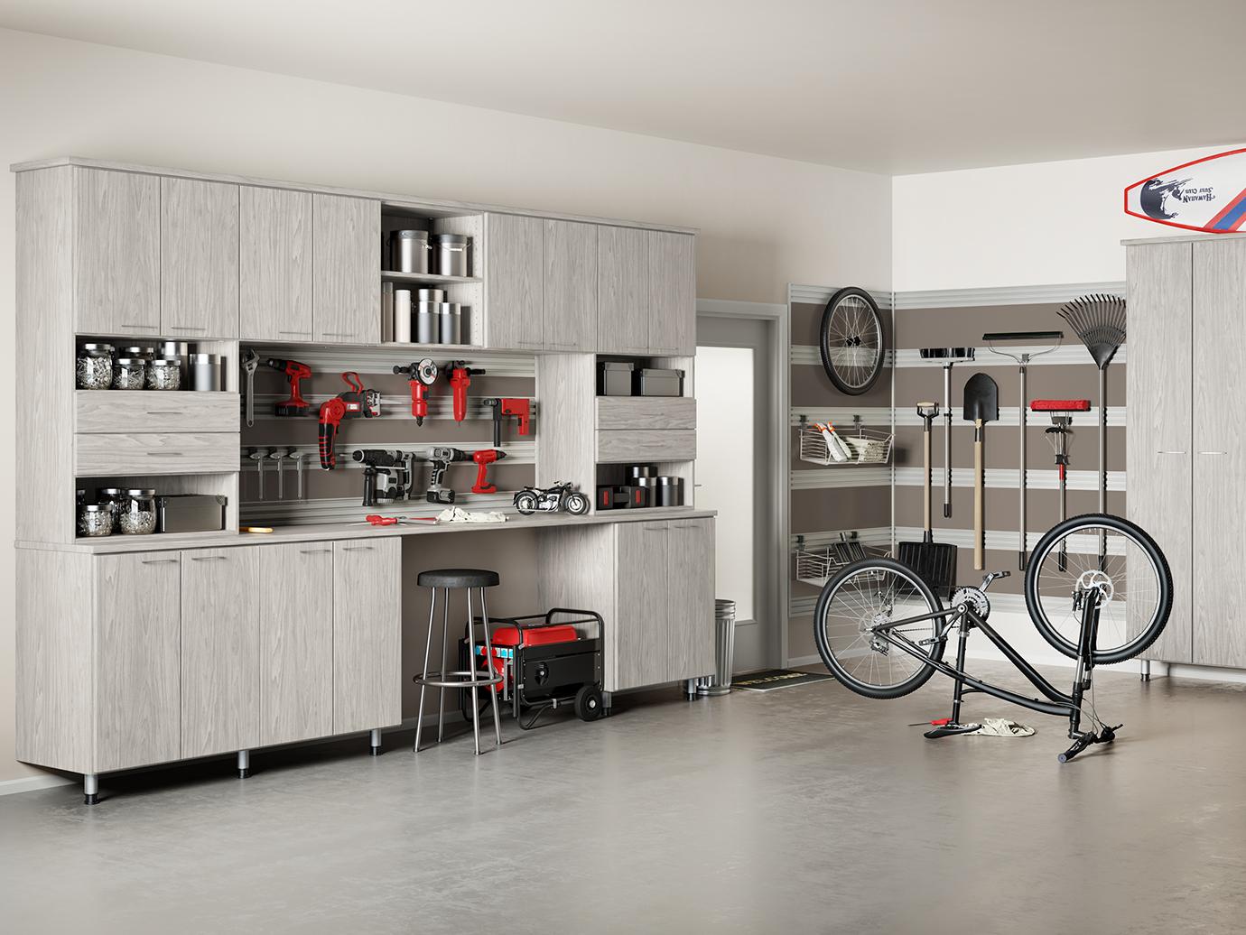 Custom mudroom to garage storage solutions to hold everything with cabinets, fusion wall track and shoe shelves by California Closets