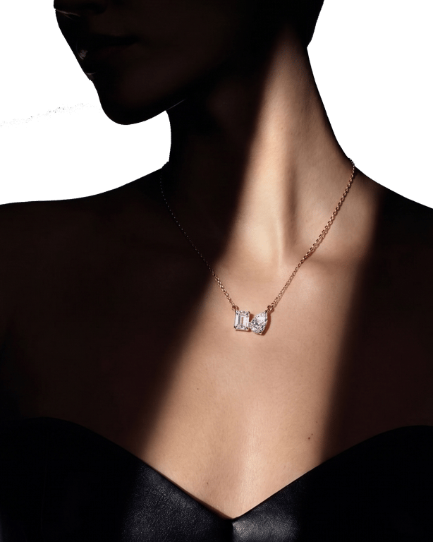 A two-stone diamond pendant on a fine rose-gold chain, worn
