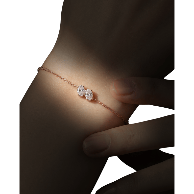 A two-stone rose-gold chain bracelet, worn at the wrist
