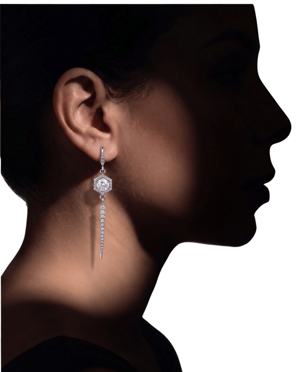 A long diamond drop earring, worn in profile