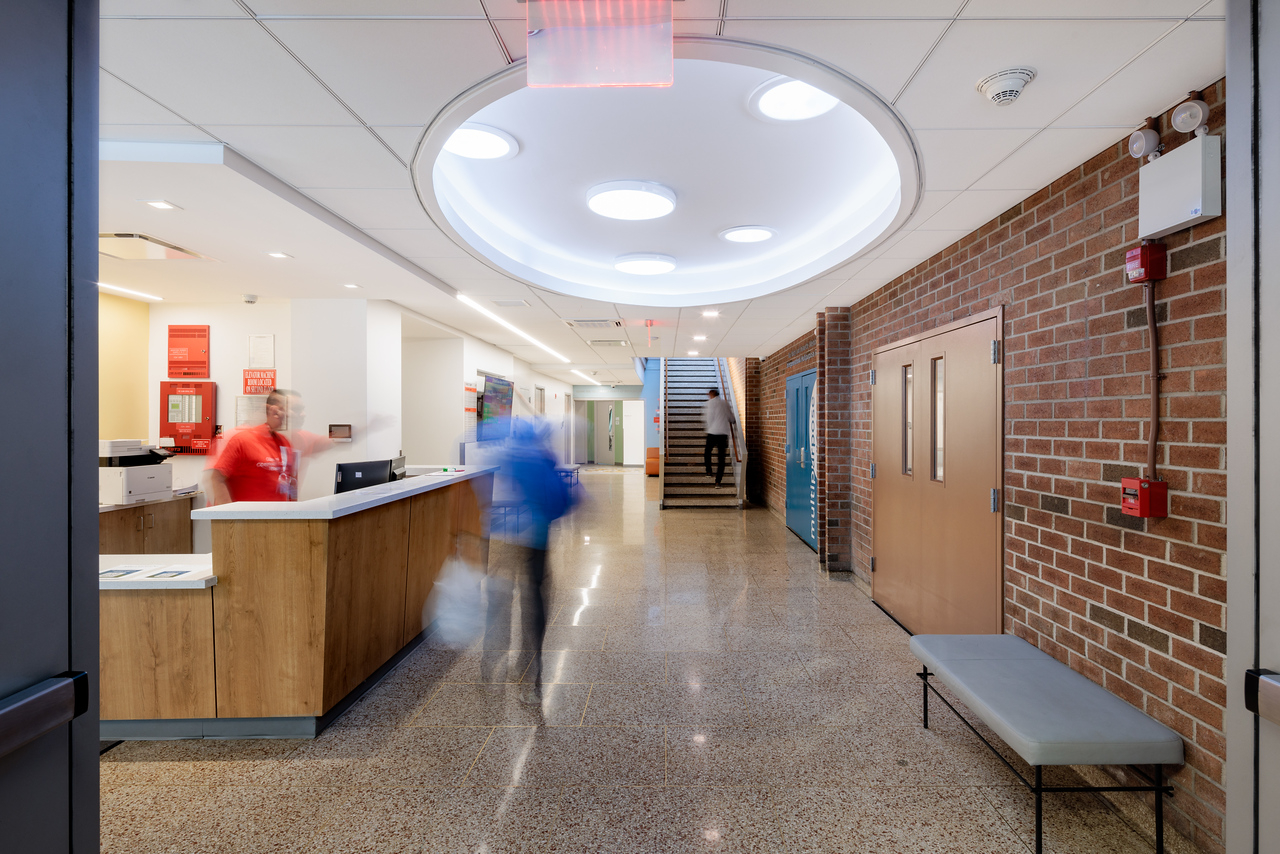 Updated entry lobby with solar tubes and re-clad stairs beyond the Multi-Purpose Room doors.