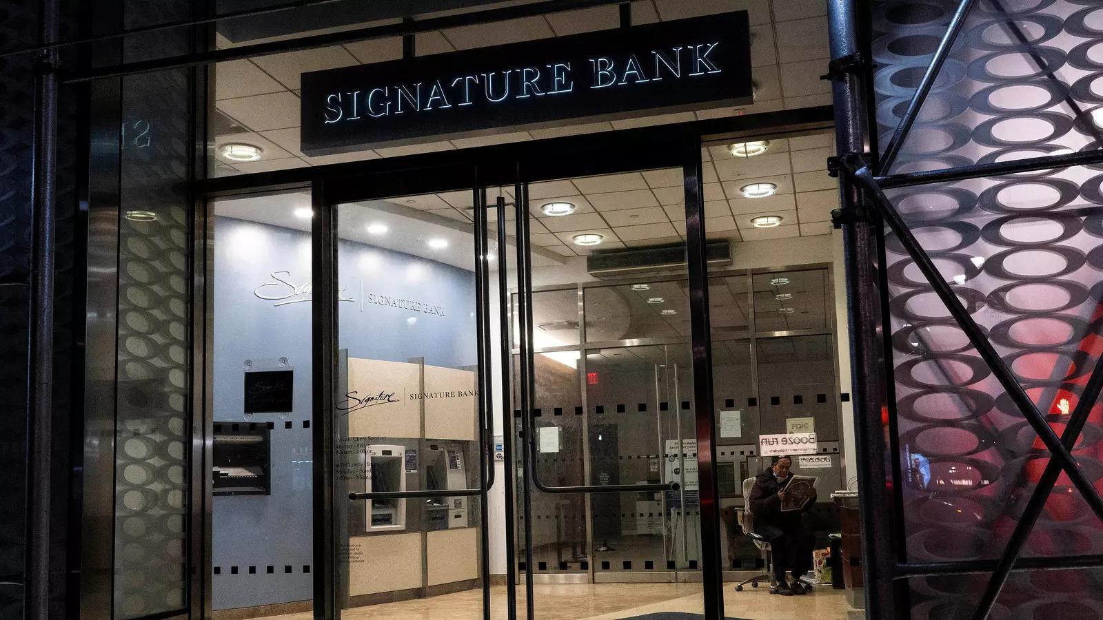 a security worker reads a newspaper inside of one the signature bank branches in new