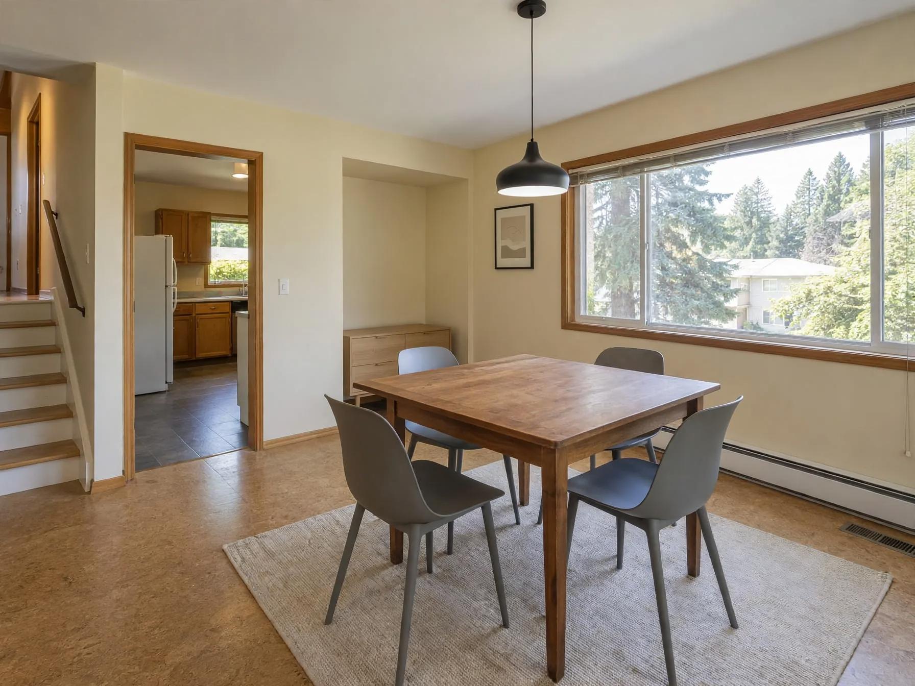 Minimalist dining room after AI restyle by Renovaitor: Large picture window framed by timber molding in dining area