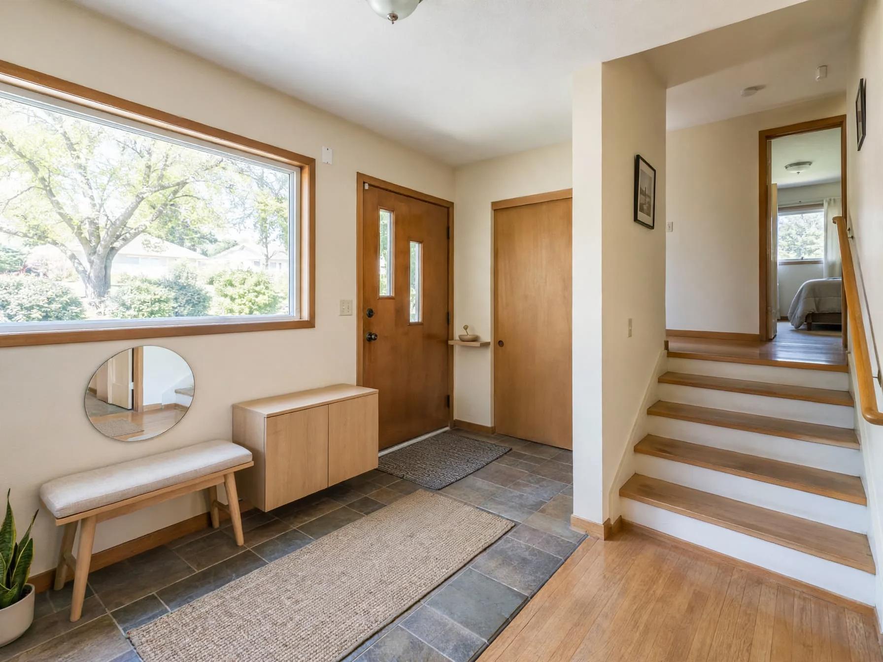 Minimalist entryway after AI restyle by Renovaitor: Large picture window entryway with minimalist bench and mirror