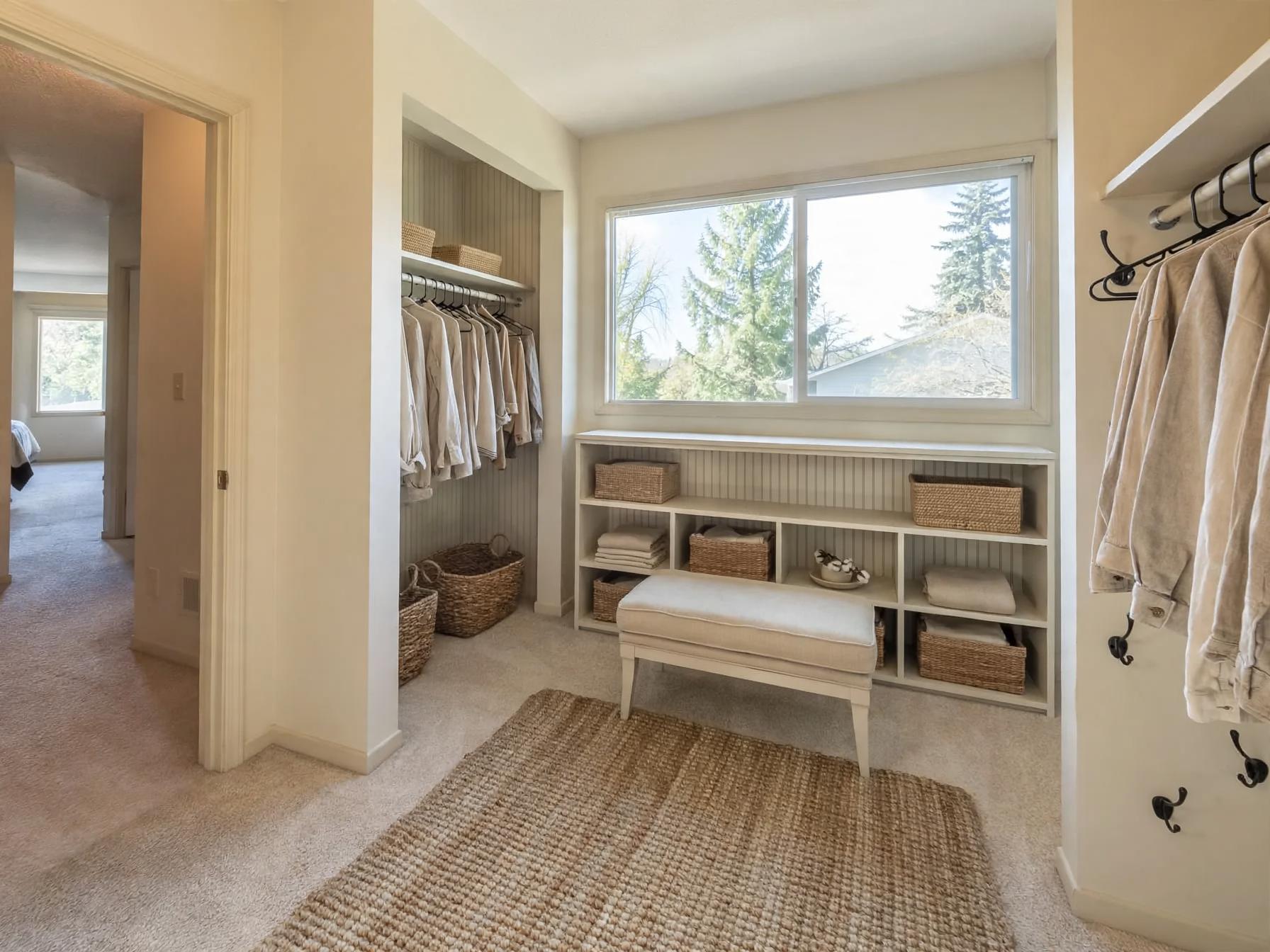 Farmhouse walk in closet after AI restyle by Renovaitor: Large window framed by open shelving and woven textures