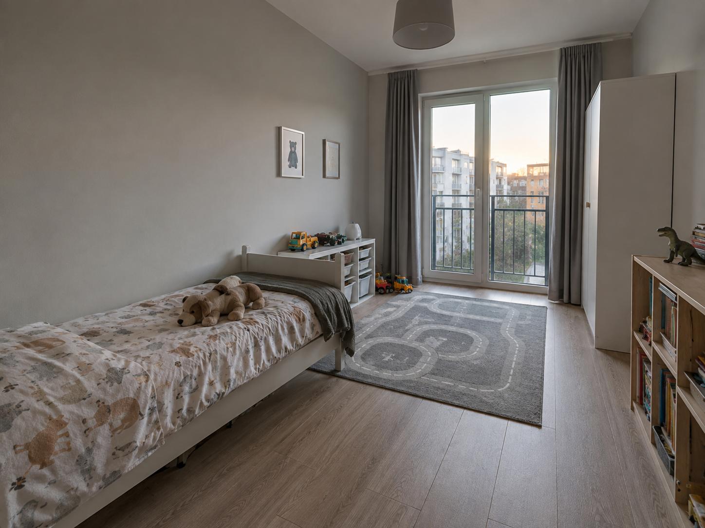 Neutral kids-room with low single bed, animal-print bedding, toy storage near window and grey road-pattern rug