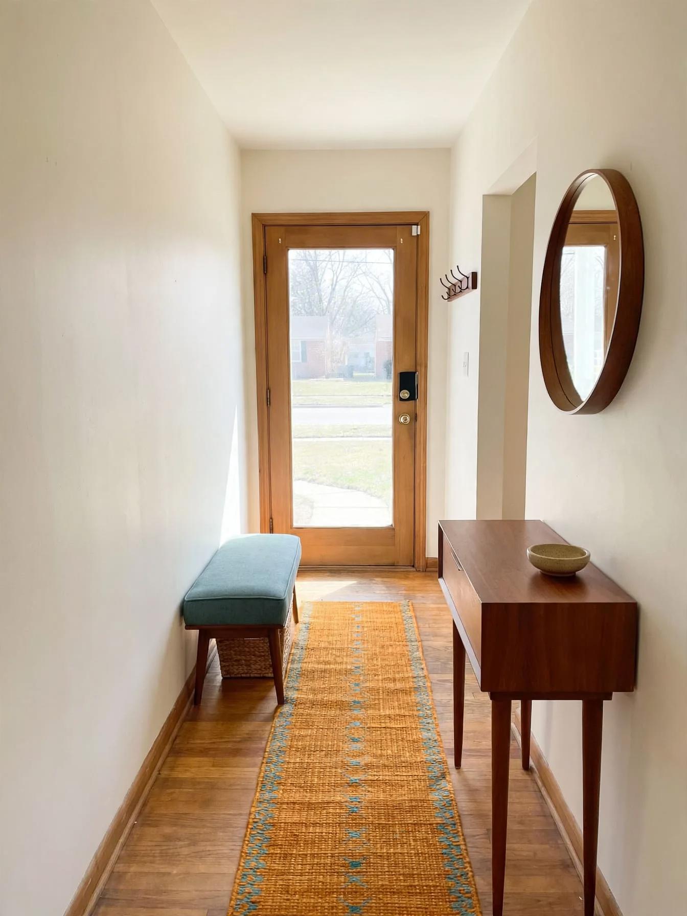 Mid century modern entryway after AI virtual staging by Renovaitor: Narrow entry with mid-century bench and runner layout
