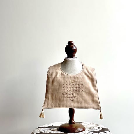 Birthday calender  bib   ecru beige