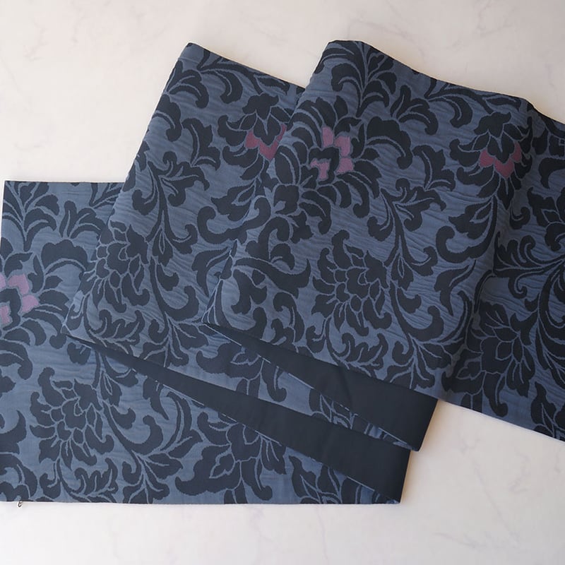 膨れ織り袋帯深緑地唐花葡萄聖樹文