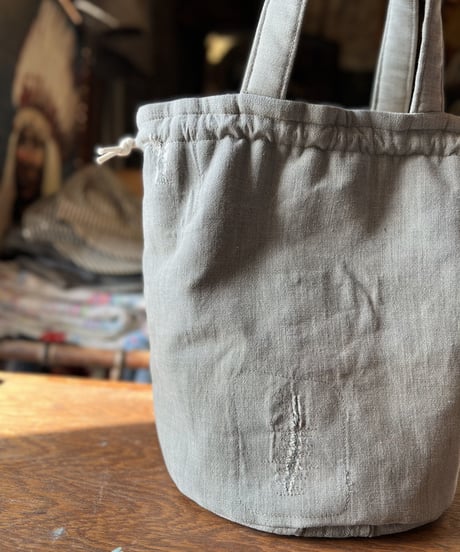 A drawstring purse using a vintage work shirt.