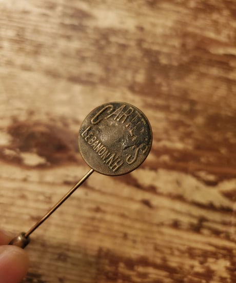 Brass pin with vintage change button.