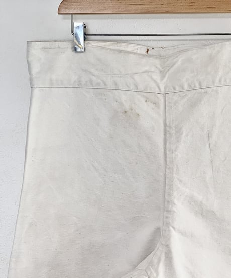 ~1940s French side button white canvas pants.