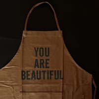 DRESSSEN DR(BRN)3  APRON "YOU ARE BEAUTIFUL "BROWN COLOR