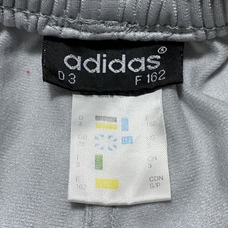 【USED】90'S ADIDAS SIDE SEAM SLITS WITH SNAP BUTTON TRACK PANTS SILVER