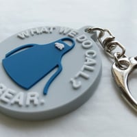 DONATION（寄付3,000円）→キーホルダー WHAT WE DO CALL？：エプロン