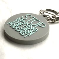 DONATION (寄付3,000円)→キーホルダー：STOP MAKING THE SIGN PODCAST（グレー×ホリゾンブルー）