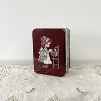 antique girl and doll tin can