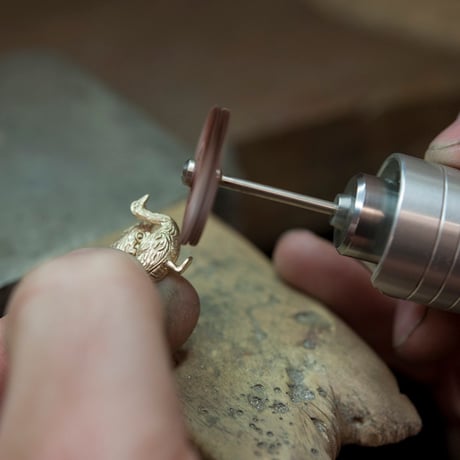 golden goose with an egg pendant