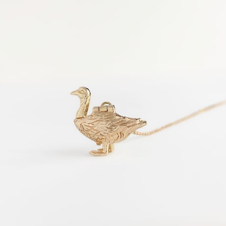 golden goose with an egg pendant