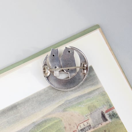owls on engraved crescent brooch