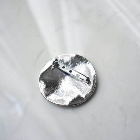 flat metal brooch