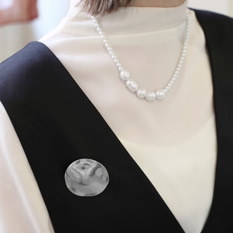 flat metal brooch